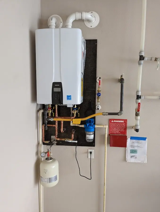 Professional plumber installing copper piping in a Whitpain home